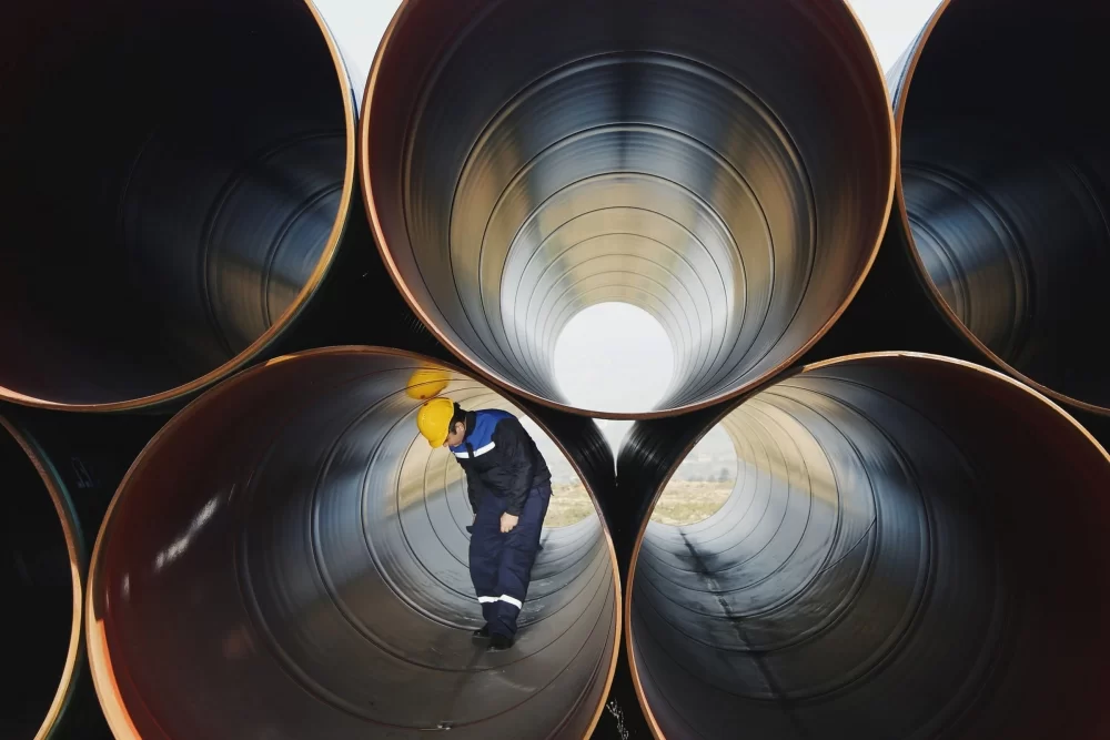 ETQ Reliance Risk Register application with worker in industrial pipe