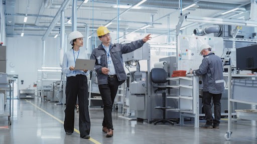 stock image of quality managers walking through a warehouse facility